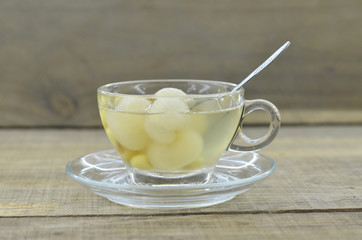 Lotus tea, longan delicious in cup on wooden table