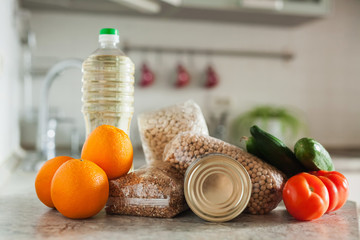 Food supplies. Stock of non-perishable foods, vegetables and fruits in the kitchen. Sunflower oil, buckwheat, pasta, beans, chickpeas, canned food. Food delivery, Donation, coronavirus quarantine.