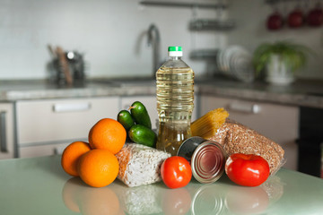 Food supplies. Stock of non-perishable foods, vegetables and fruits in the kitchen. Sunflower oil, buckwheat, pasta, beans, chickpeas, canned food. Food delivery, Donation, coronavirus quarantine.