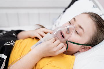 The sick girl inhales. Treatment of the child. Contagious disease treatment. Infectious illness...
