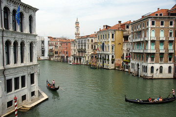 View from Rialto bridge.  City landscape with grand canal, buildings and gondolas.