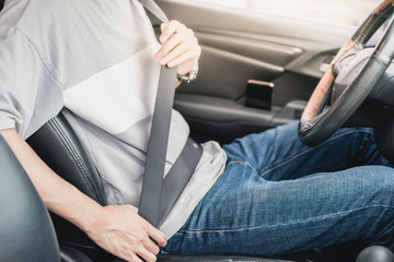 a male driver is  wearing seatbelt  - obrazy, fototapety, plakaty