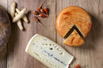 portions of cheese on wooden background