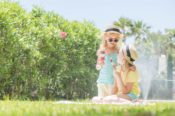 Obraz premium Portrait of a two cute girls with ice cream. Summertime fun.