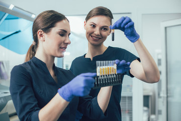 Friendly females smiling while working with samples in the laboratory