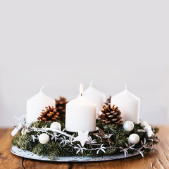 Lighting the first candle on the Advent Christmas Wreath. Square format.