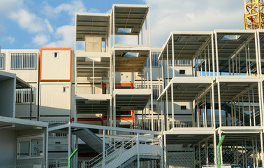 Prefabricated modular offices. Stacking of boxes for construction site.