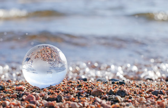 Glass gobe sphere on the sea as concept