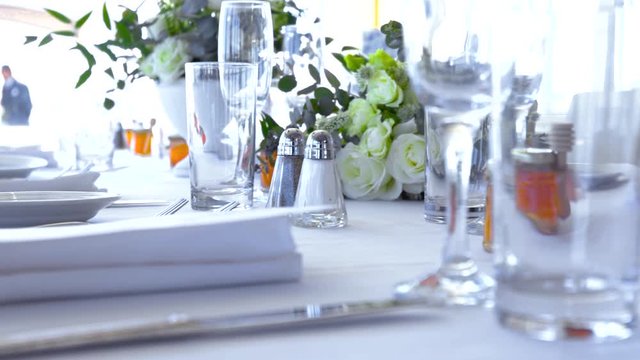 Camera Sweep across dinner table design with orange honey jar and flowers