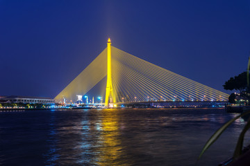 Naklejka na ściany i meble 03/02/2020 Bangkok, Thailand. illuminated in the evening Rama 8 Bridge across the Chao Phraya River