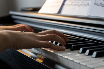 Obraz premium Young girl playing digital piano...