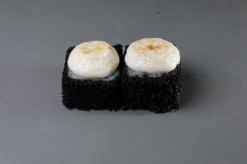 sushi on a black plate
