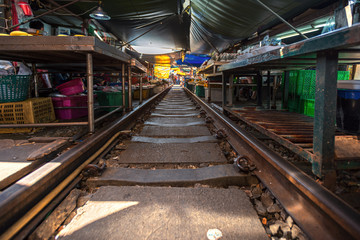 Thailand, Samut Songkhrami, Mae Klong railway market also called Siang Tai. Tourists walk along the train tracks and make purchases from local sellers. Pop place among tourists from all over the world