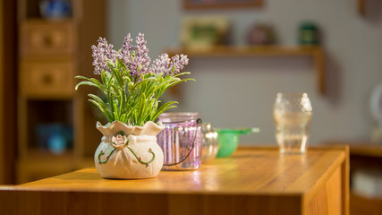 Potted lavender on wooden table in living room, modern interior bouquet decoration, depth of field