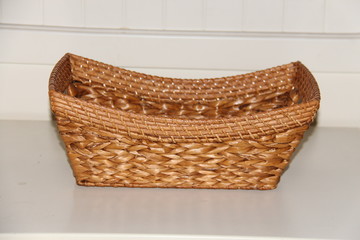 Wicker boat shape basket, isolated on white background. Traditional handicraft
