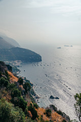 Nature landscape, vertical photo. Bay with ships and boats. View from the mountain of the Nerano village, near Punta Campanella, by Amalfi Coast, Italy