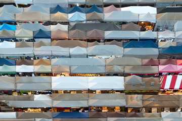 Bangkok, Thailand, Top view of Train Night Market Ratchada (Talad Rot Fai) flea market with plenty of shops with colorful canvas and amazing pattern of roofs near MRT line 