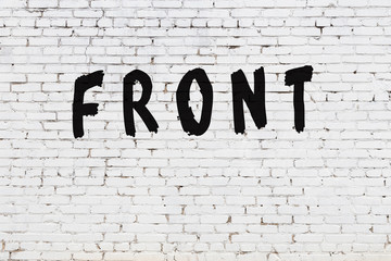 Word front painted on white brick wall - obrazy, fototapety, plakaty