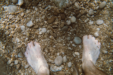 Underwater view of the Ieranto beach, in the southern Italy, Sorrento. The shot is takend during a sunny summer day, with rays of light coming inside the water. Amalfitana, Npoli coast