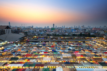 Bangkok, Thailand, Top view of Train Night Market Ratchada (Talad Rot Fai) flea market with plenty of shops with colorful canvas roofs near MRT line