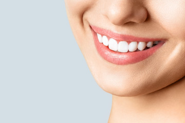 Beautiful female smile after teeth whitening procedure. Dental care. Dentistry concept