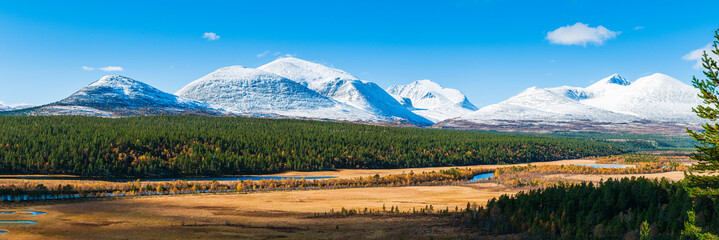 Panorama of snowcapped Norweigan mountains landscape.