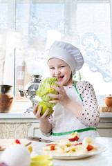 A child in the kitchen playing cook
