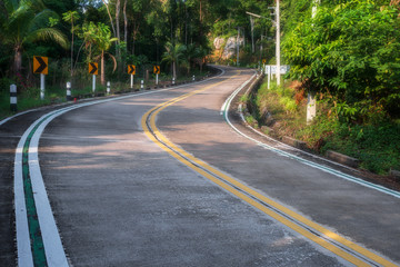 .empty winding road in jungle between Coconut palms in tropical island Ko Pha Ngan to Haad Sadet Beach