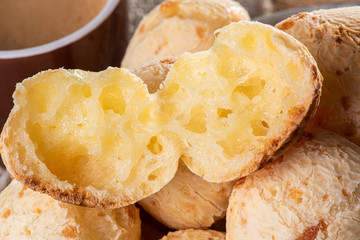 Brazilian cheese bread in a bowl. Wood background.
