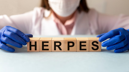 Herpes - word text from wooden cube blocks with letters, viral diseases herpes viruses concept....