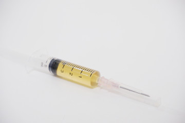 Close-up syring needle contain vaccine on white background