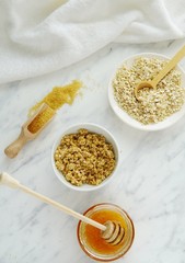 Lips, face or body scrub with oats, brown sugar and honey, natural cosmetics, homemade beauty product, flat lay, marble background.