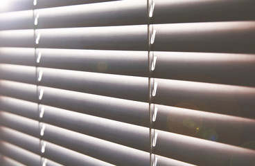 Sunlight through closed window blinds