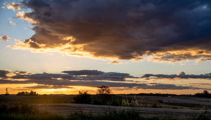 Dusk with sun and clouds on an agricultural production farm in the south of Brazil