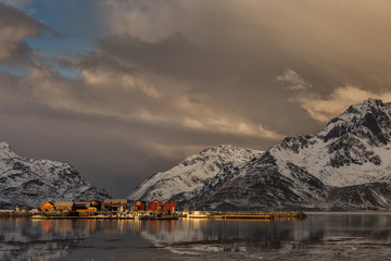 Beautiful landscape with clouds, fog, water, reflectaion in background at Lofoten Island, Norway