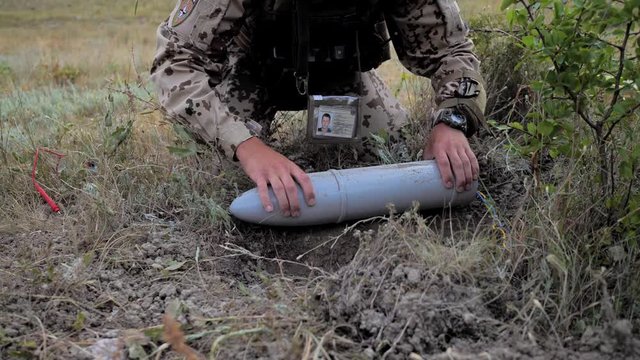 Airsoft. The sapper finished his work. takes the projectile out of the pit