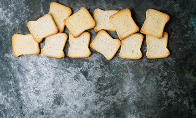 Slices of toasted bread in a line