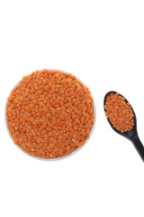 Close up of Orange Masoor Dal (Red Chief) lentil lens isolated on white background with Spoon.	