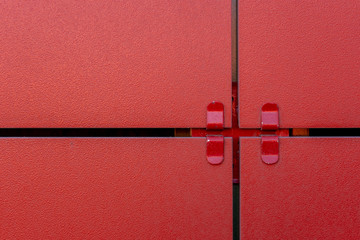 Fragment of a ventilated facade made of ceramic tile in red.