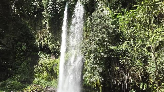 A stunning two levelled waterfall in Lombok, Indonesia. Tiu Kelep Waterfall is surrounded by lush green plants from each side. Long and powerful waterfall. Beauty of the nature.
