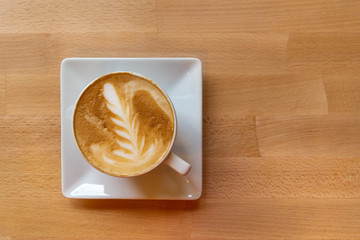 Top view Flat lay of a coffee cup on a wooden table with copy space.