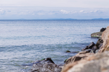 The sky and the calm sea near the rocky coast