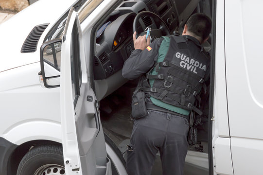 A Police Officer From The Spanish Civil Guard Inspects A Vehicle During A Checkpoint Mounted In The Covid Coronavirus Pandemic19