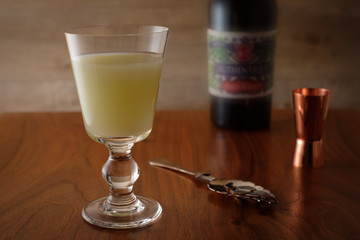Glass of absinthe with spoon and beaker