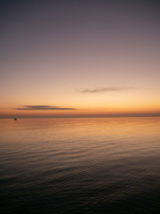 Sunset on small waves seaside beach