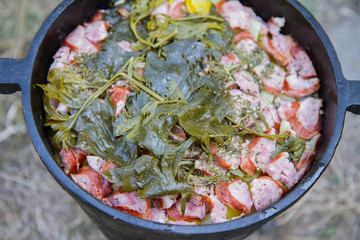 Traditional one pot dish of meat and vegetable done in a cast iron cauldron over a bonfire