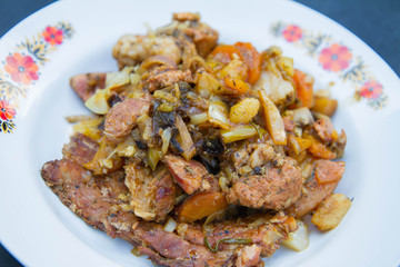 Traditional one pot dish of meat and vegetable done in a cast iron cauldron over a bonfire - a...