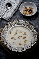 Kheer or Payasam is a type of rice pudding from the Indian subcontinent, made by boiling milk and sugar and is flavoured with dry fruits and nuts, served in decorative plate.