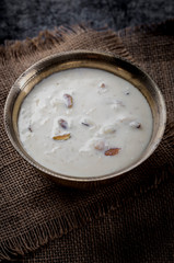 Kheer or Payasam is a type of rice pudding from the Indian subcontinent, made by boiling milk and sugar and is flavoured with dry fruits and nuts, served in metal bowl.