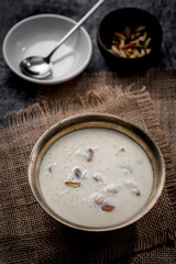 Kheer or Payasam is a type of rice pudding from the Indian subcontinent, made by boiling milk and sugar and is flavoured with dry fruits and nuts, served in metal bowl.